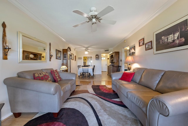 living room featuring ornamental molding and ceiling fan