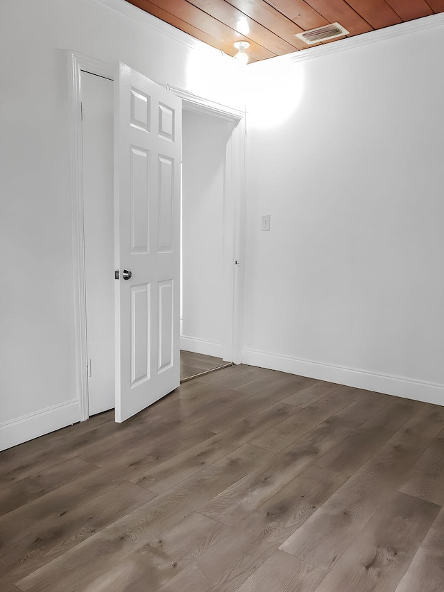 empty room with wood-type flooring and wood ceiling