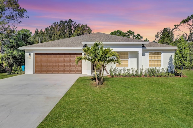 view of front of home featuring a yard and a garage