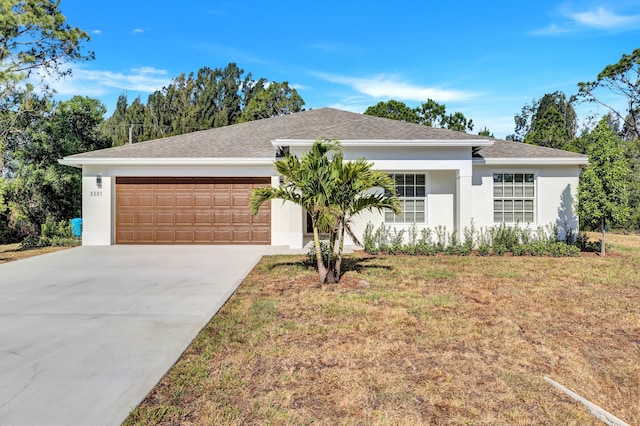 ranch-style house with a garage and a front yard