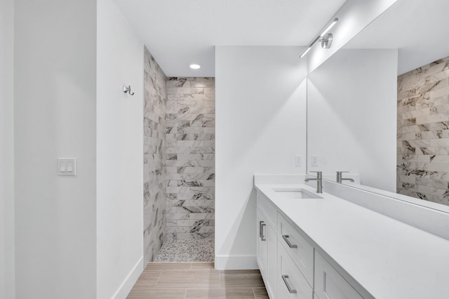 bathroom featuring vanity, tile floors, and tiled shower