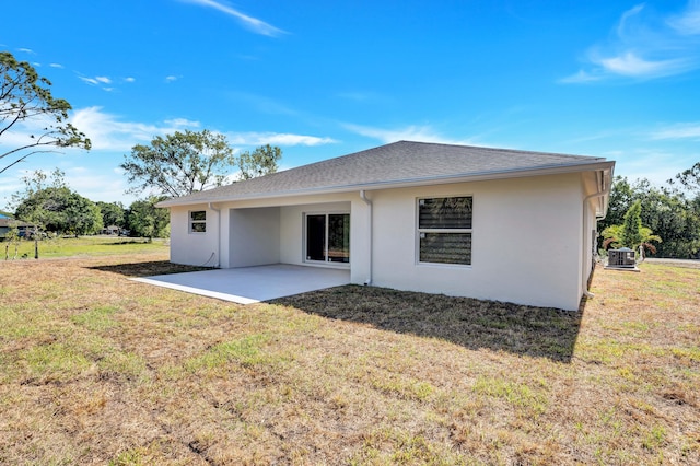 back of property with a patio and a lawn