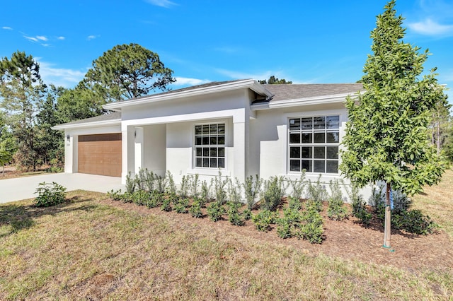 single story home featuring a garage and a front lawn