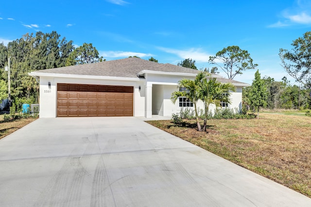 view of front of home with a garage and a front lawn