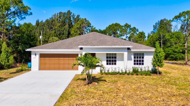 ranch-style home with a garage and a front yard