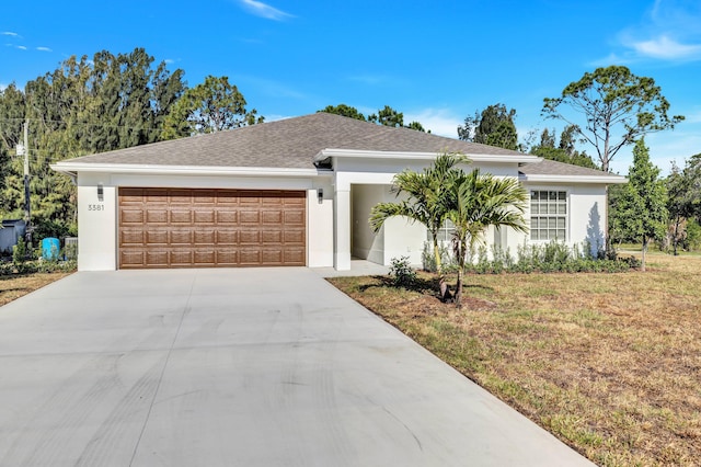 ranch-style home with a garage and a front lawn