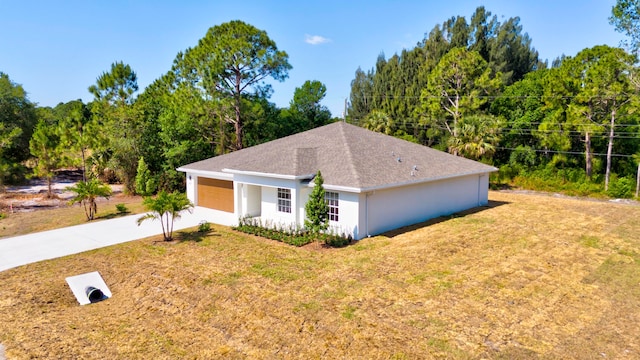 view of front of house with a garage and a front yard