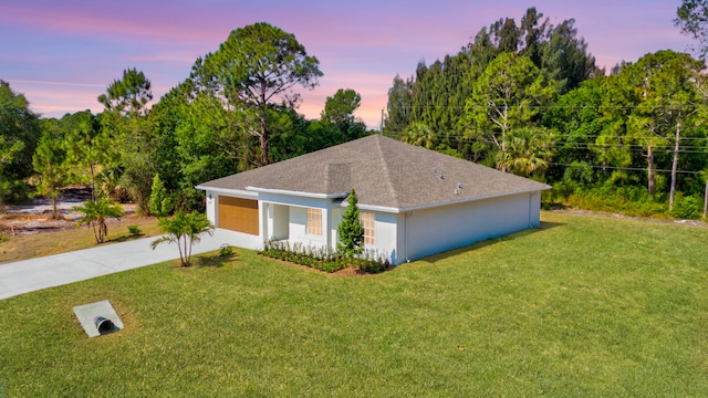 view of front facade with a lawn and a garage