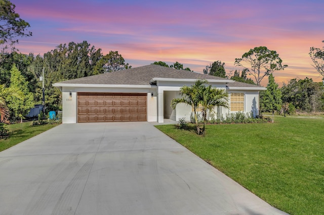 ranch-style house with a lawn and a garage