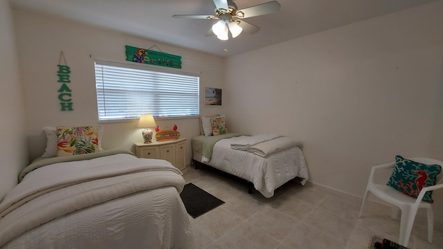 bedroom featuring ceiling fan and light tile floors