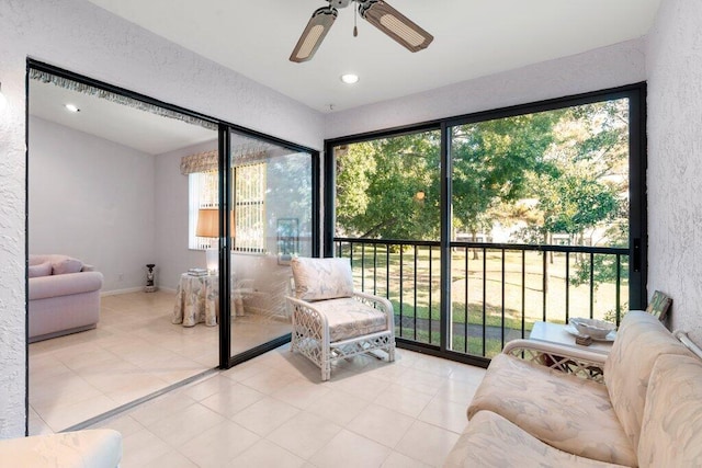 interior space with ceiling fan