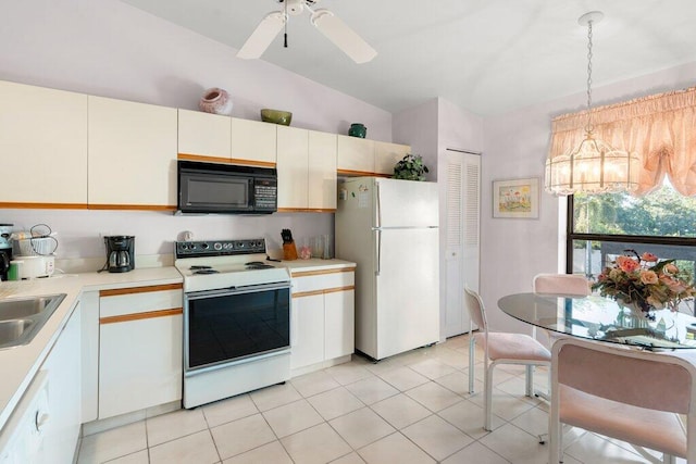 kitchen featuring hanging light fixtures, white appliances, vaulted ceiling, ceiling fan with notable chandelier, and white cabinets