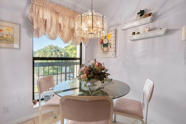 dining room featuring tile flooring and a chandelier