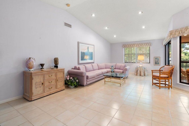 living room featuring high vaulted ceiling and light tile floors