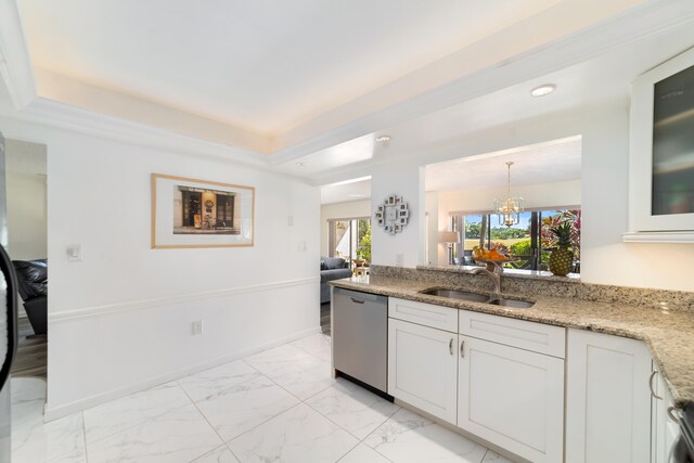 kitchen featuring light stone countertops, a tray ceiling, stainless steel dishwasher, sink, and white cabinets