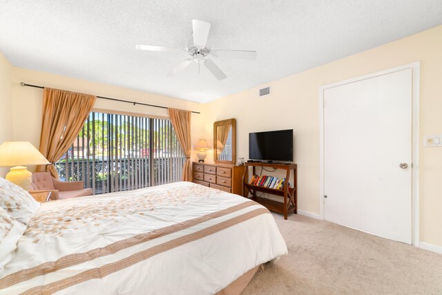 bedroom featuring a textured ceiling, carpet, ceiling fan, and access to exterior