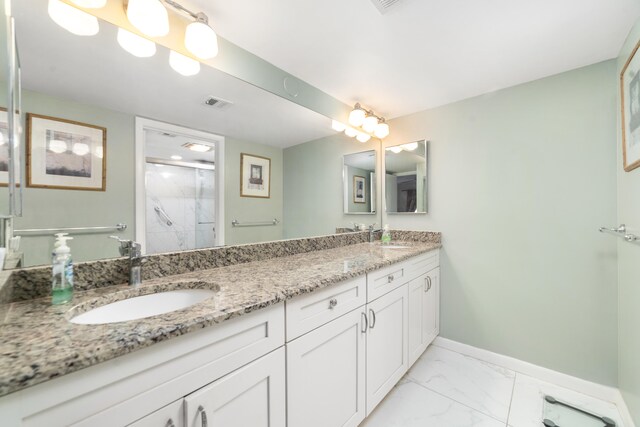 bathroom featuring tile floors, a shower, and dual bowl vanity