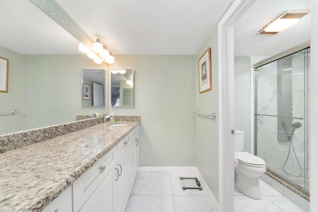 bathroom featuring tile floors, a shower with door, toilet, and vanity