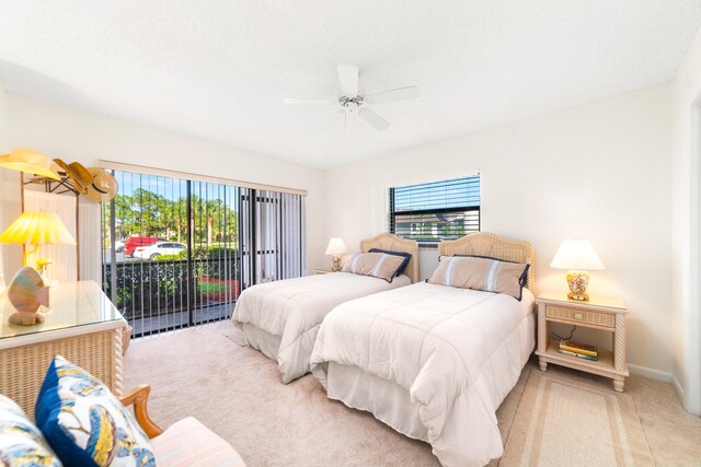 bedroom with ceiling fan, multiple windows, and access to exterior