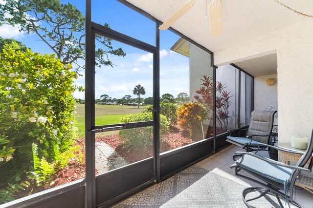 sunroom featuring ceiling fan