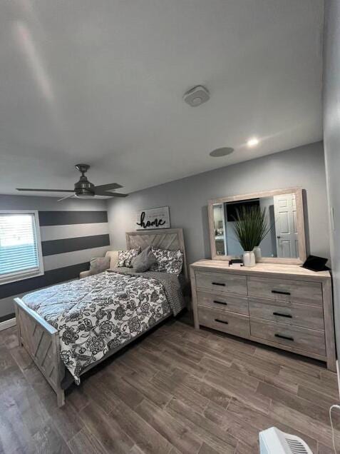 bedroom featuring dark hardwood / wood-style flooring and ceiling fan