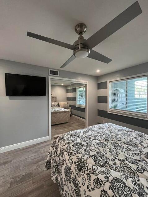 bedroom with hardwood / wood-style flooring and ceiling fan