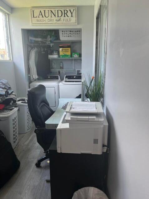 office area with washer and clothes dryer and wood-type flooring