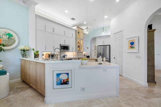 kitchen with decorative light fixtures, kitchen peninsula, crown molding, and stainless steel appliances