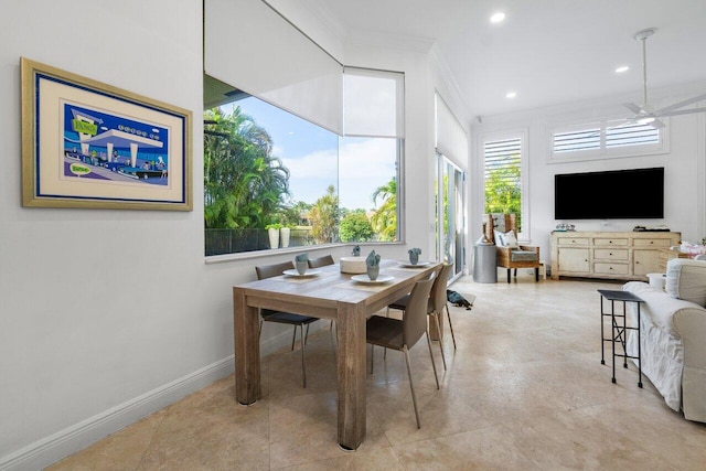 dining room with ceiling fan and crown molding