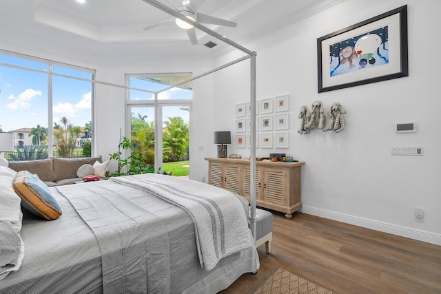 bedroom featuring ceiling fan, dark hardwood / wood-style flooring, and ornamental molding