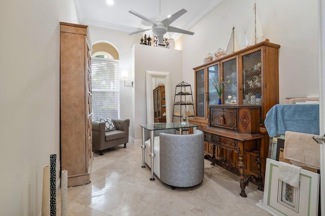 sitting room featuring ceiling fan and ornamental molding