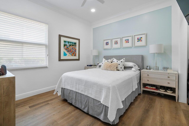 bedroom with ceiling fan, hardwood / wood-style floors, and crown molding