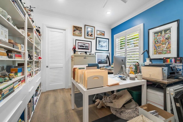 office area with light hardwood / wood-style floors and crown molding