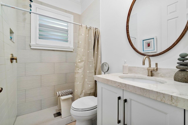 bathroom featuring toilet, vanity, and curtained shower