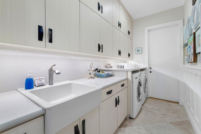 laundry room featuring cabinets, independent washer and dryer, and sink