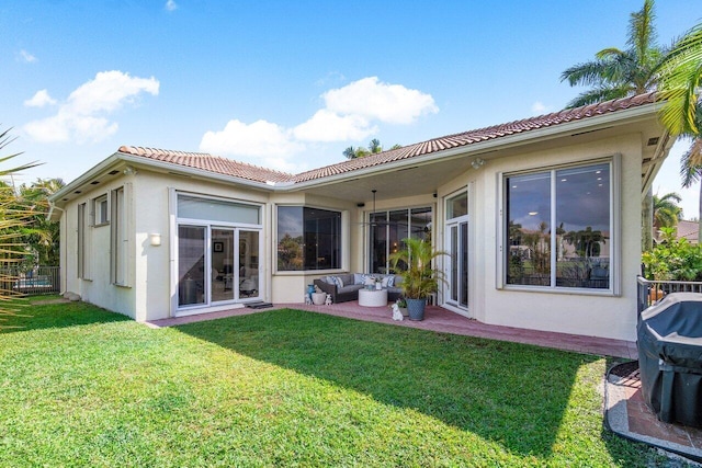 back of property featuring a lawn and an outdoor hangout area