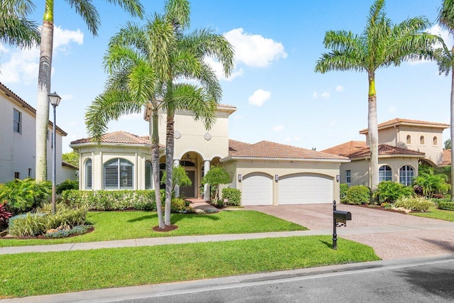 mediterranean / spanish-style house with a front lawn and a garage