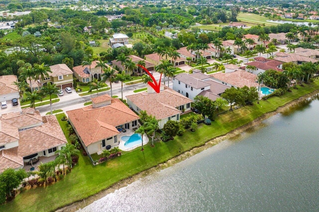 birds eye view of property with a water view