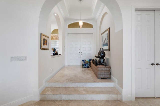 foyer featuring ornamental molding