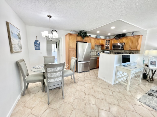 kitchen featuring decorative light fixtures, light tile flooring, an inviting chandelier, stainless steel appliances, and tasteful backsplash