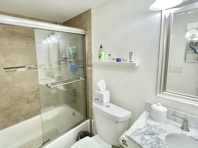 full bathroom featuring shower / bath combination with glass door, vanity, and toilet