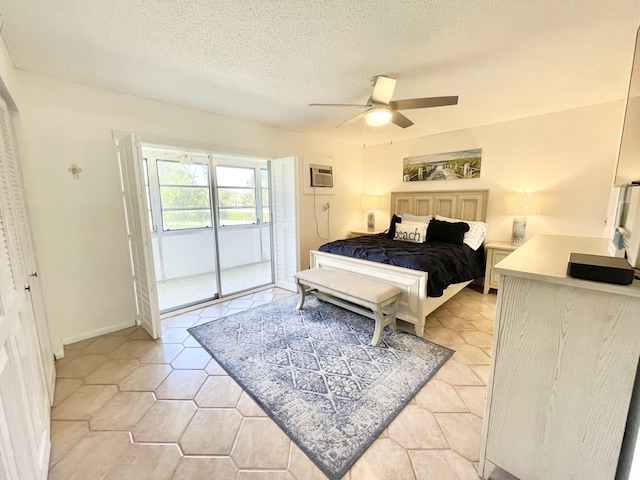 bedroom featuring ceiling fan, access to exterior, light tile floors, and a textured ceiling