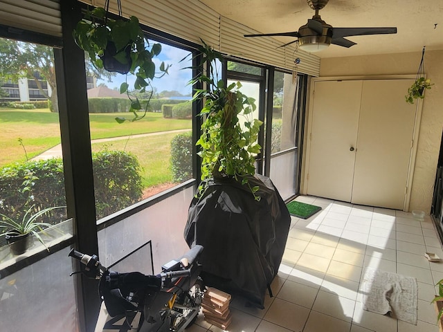 sunroom featuring ceiling fan and a wealth of natural light