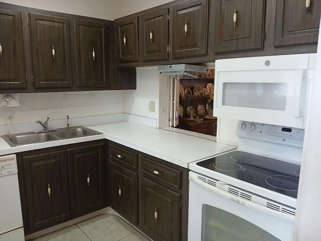 kitchen featuring white appliances, light tile flooring, dark brown cabinets, sink, and fume extractor