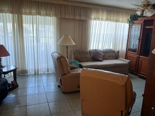 tiled living room featuring ceiling fan