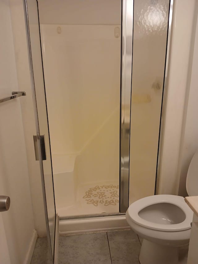 bathroom with walk in shower, tile floors, and toilet