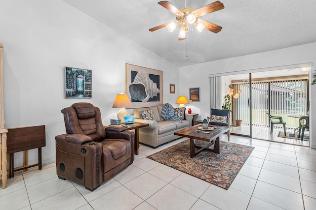 tiled living room featuring lofted ceiling, ceiling fan, and a textured ceiling