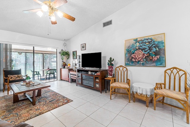 living room featuring a textured ceiling, ceiling fan, light tile patterned flooring, and lofted ceiling