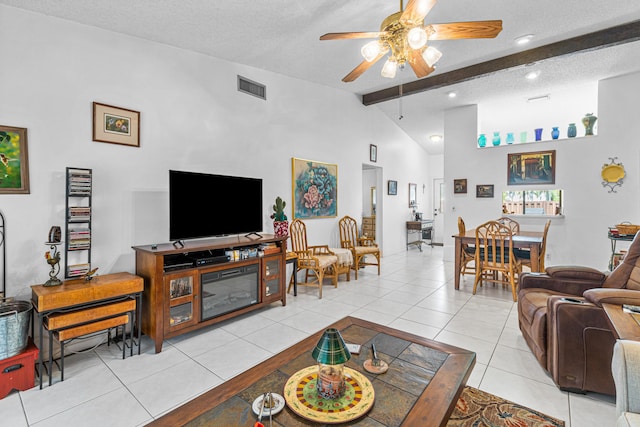 living room with ceiling fan, a textured ceiling, light tile patterned floors, and vaulted ceiling with beams