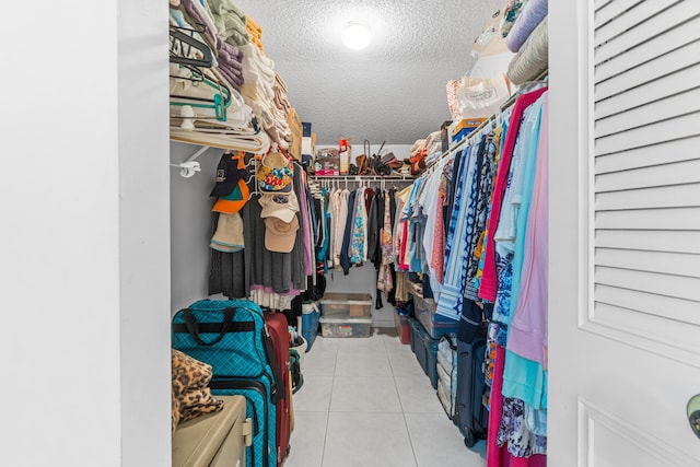 walk in closet with light tile patterned flooring